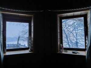 Two windows with snow covered fields in the distance