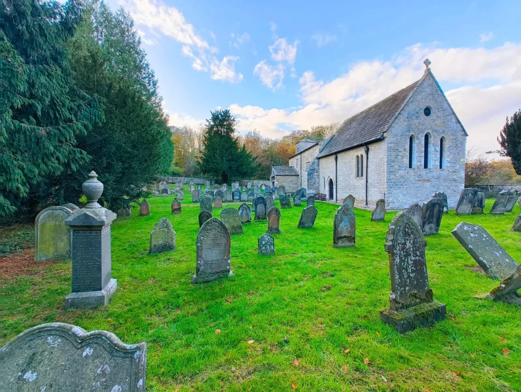 Church yard with various gravestones in the foreground